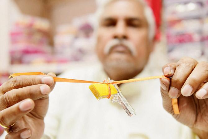 A gun keychain rakhi by Patwa