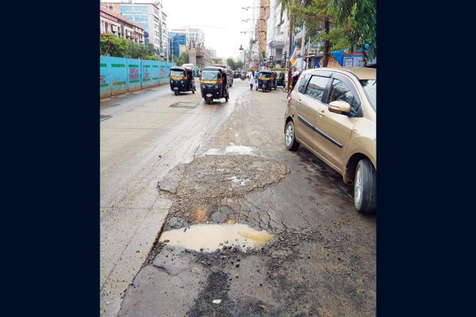 Potholes like this one near Infiniti Mall on the busy New Link Road in Andheri West can jam traffic for hours. Pic/Dhaval Shah