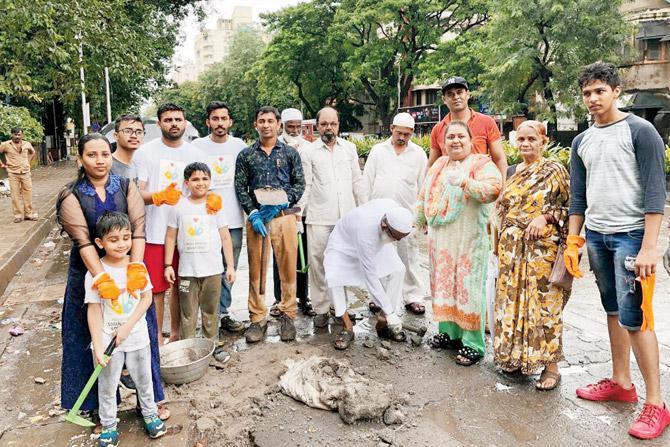 Ansari filled potholes on Linking Road, Khar, with the help of locals