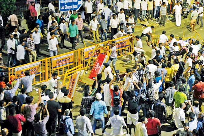 Dravida Munnetra Kazhagam supporters vandalise barricades as they react to the news of party president M Karunanidhi