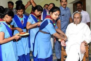 Women and schoolchildren tie Rakhi to Odisha Chief Minister Naveen Patnaik