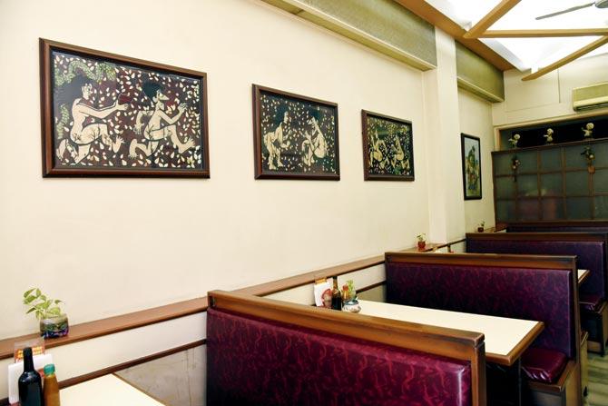 The simple interiors of the restaurant. The artworks on the wall show Adam chasing Eve after eating the forbidden fruit and vice versa