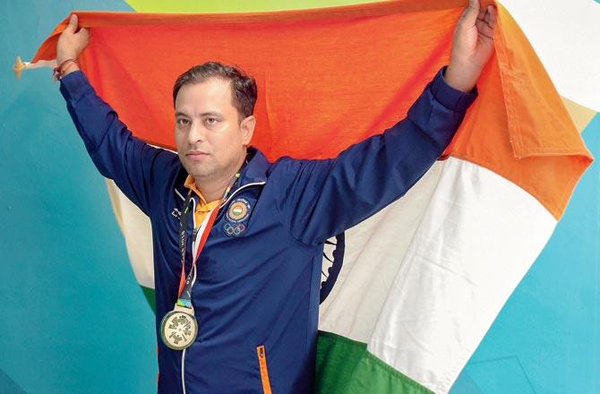 Sanjeev Rajput celebrates after clinching silver. Pics/AFP, PTI