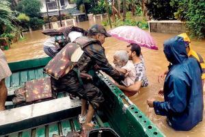 Army personnel rescue flood affected people in Ernakulam district on Tuesday. Pic/PTI