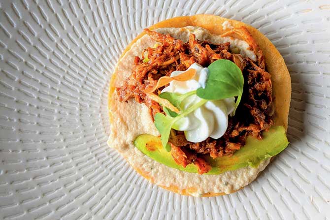 Chicken chipotle tostada with avocado and sour cream