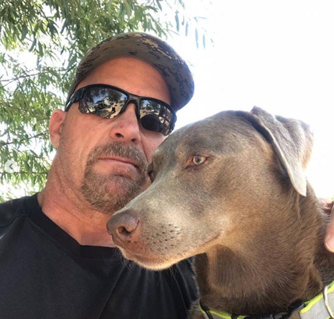 In pic: Stone Cold Steve Austin shared this picture with his dog and captioned, 'Moolah and me. #silverlab #nevada'