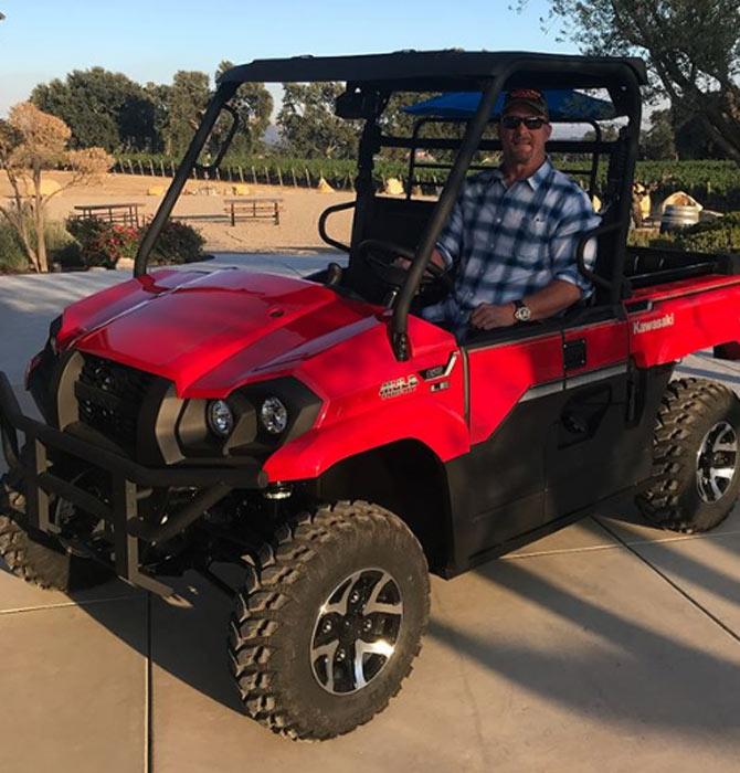 Stone Cold Steve Austin enjoying a drive in a sand buggy. He captioned, 'I had a blast rolling out the brand new 2018 Kawasaki Mule Pro MX at @jdusiwines in Paso Robles today. First class all the way. Let the good times roll. @kawasakiusa #mulepromx #strong'