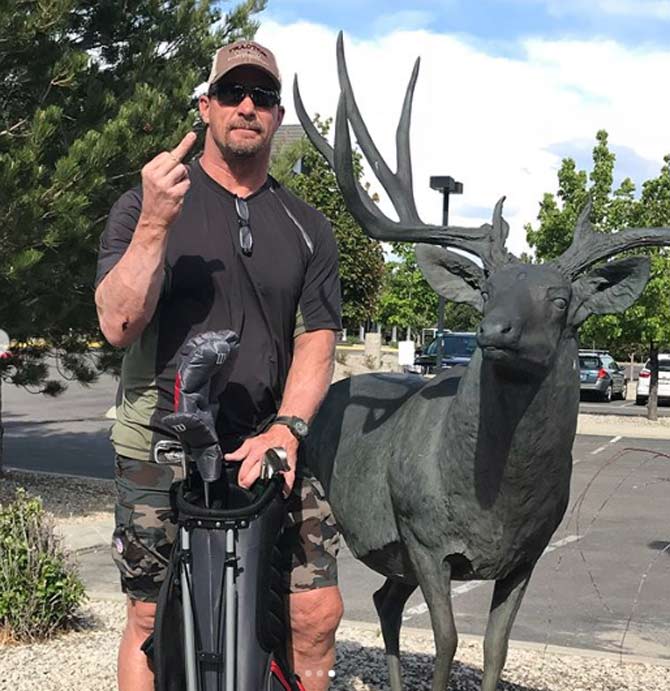 Stone Cold Steve Austin looks to be in his element in this picture, showing his middle finger to the cameras with a 'stoned' animal beside him.