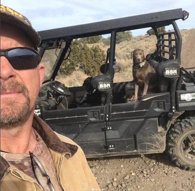 Stone Cold Steve Austin posted this picture of himself driving his buggy with his dogs in the backseat and captioned, 'Riding Buck the Mule with Cali and Moolah.' 