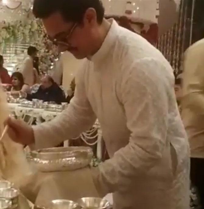 In photo: Aamir Khan snapped serving food to the guests during Isha Ambani and Anand Piramal's grand wedding held at Antilia in South Mumbai
