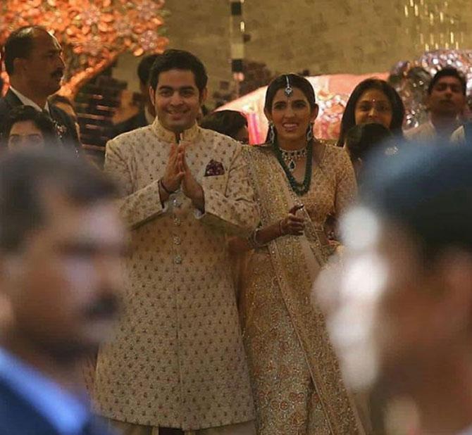 In photo: Akash Ambani and Shloka Mehta snapped by the shutterbugs as the two welcome guests during Isha Ambani and Anand Piramal's wedding at Antilia in South Mumbai