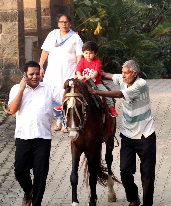 The social media sensation cut his lavish cake by the beach with parents adjusting the cake, while the little lad is sitting on the table in awe of it. Dressed in a denim jacket and cute red baby pants, Taimur looked as cute as a cupcake. In picture: Taimur Ali Khan enjoys a horse ride in Bandra.