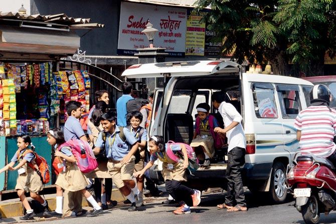 Vans stop close to the school gates until all the children get off, causing a jam here