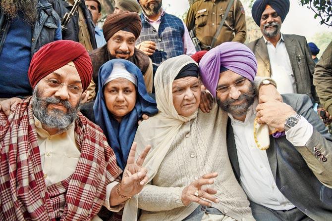 (L-R) DSGMC President Manjit Singh G K, Nirpreet Kaur and Jagdish Kaur, whose family members were killed, and Akali Dal MLA Manjinder Singh react after the verdict