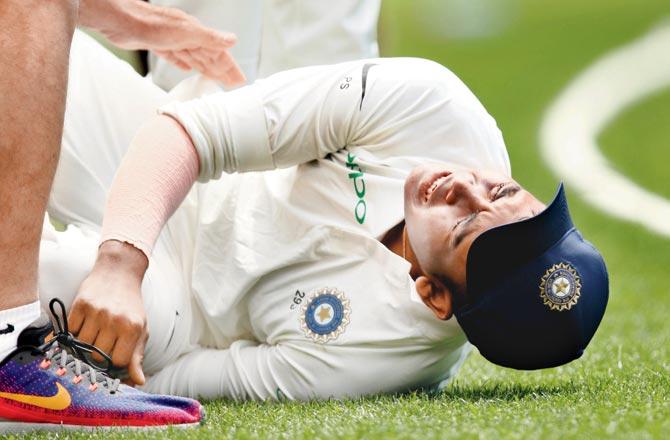 Prithvi Shaw in pain after suffering an ankle injury while attempting a catch on Day Three of the warm-up match against Cricket Australia XI at the Sydney Cricket Ground yesterday. Pics/Getty Images, AFP, PTI
