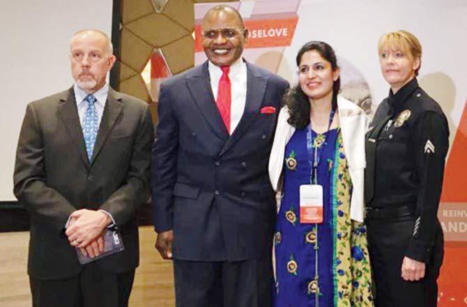 Nidhi Chaphekar (in blue) at a peace summit held in the city in September. She is with police officers from the US, where they presented her with the New York Police Department award