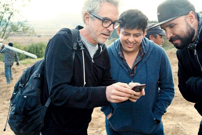 Alfonso CuaroÌu00c2u0081n (left) mentoring Chaitanya Tamhane (centre) during the shoot of Cuaron