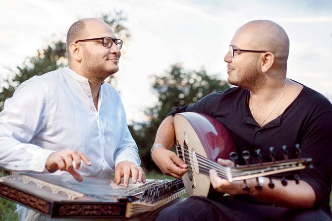 Amine Mraihi (right) plays the oud while his brother, Hamza, plays the qanun