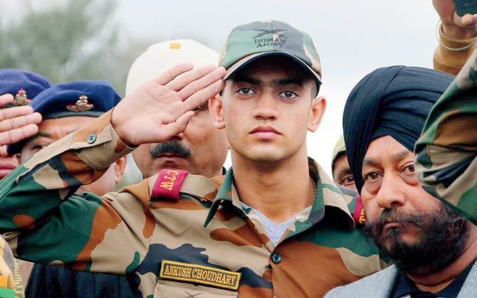 Ankush, son of Indian Army JCO Madan Lal Choudhary, who was killed in the terrorist attack at Sunjuwan Army camp, salutes his father