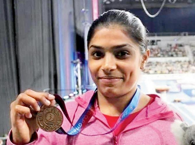Gymnast Aruna Reddy poses with her World Cup bronze which she won in the vault event on Saturday
