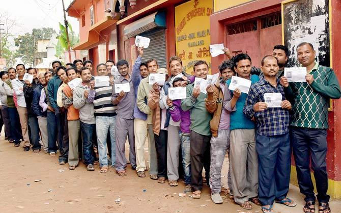 Voters wait in queue to cast their votes, at a polling station in Dimapur, Nagaland on Tuesday. Pic/PTI