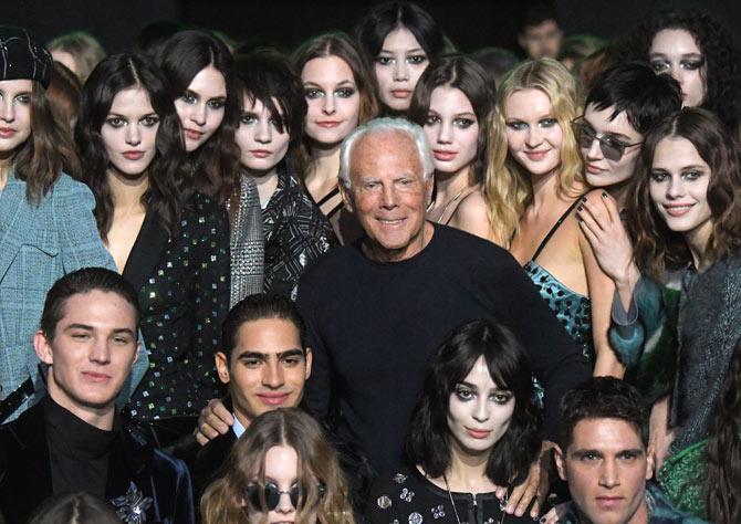 Italian fashion designer Giorgio Armani (C) poses with models at the end of his women