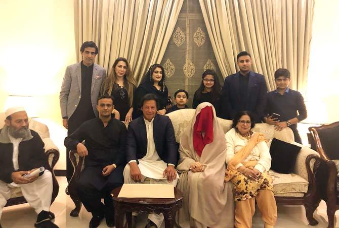 Pakistani cricketer-turned-opposition leader and head of the Pakistan Tehreek-i-Insaaf (PTI) party Imran Khan (C) posing for a photograph with his new wife Bushra Wattoo (2R) along with relatives during a nikah wedding ceremony in Lahore. Pic/AFP