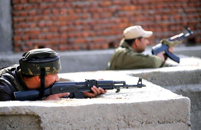 Security personnel take positions around the army family quarters at Sunjuwan Military Station during the second day of the terrorist attack, in Jammu. Pic/PTI