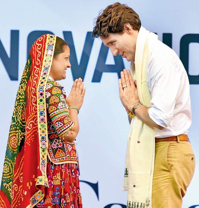 Canadian Prime Minister Justin Trudeau exchanges greetings with a village woman after being presented a shawl at the United Nations Young Changemakers Conclave in New Delhi on Saturday. Pic/PTI