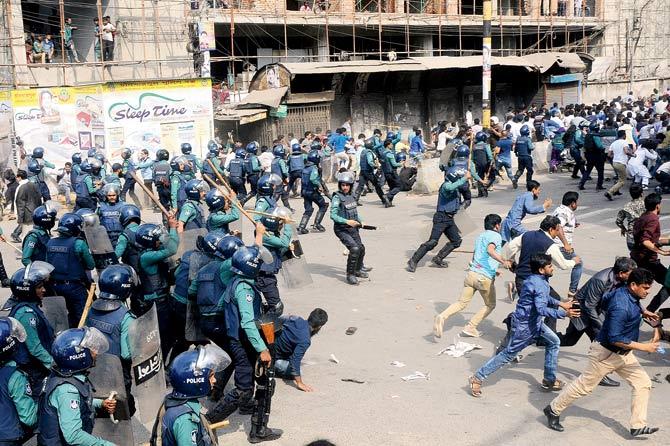Police charge towards activists of the Bangladesh Nationalist Party protesting following a verdict against Khaleda Zia in Dhaka. Pic/AFP