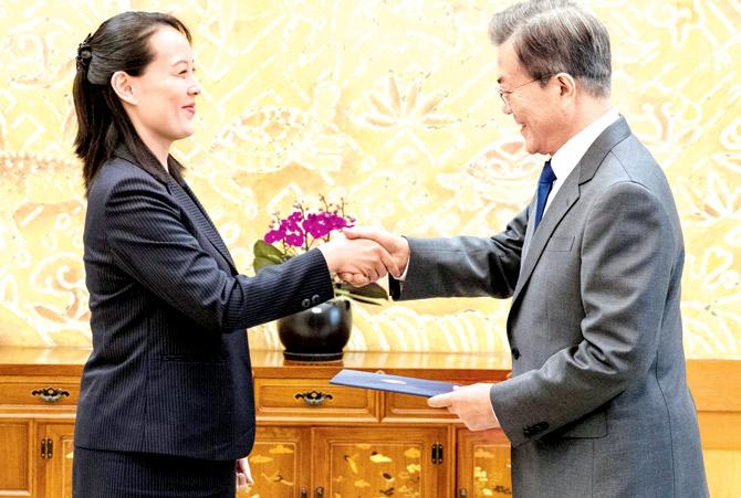 Kim Yo Jong (left) hands over an autographed letter from her brother Kim Jong Un (inset) to Moon Jae-in during their meeting at the presidential Blue House in Seoul. Pics/AFP and AP