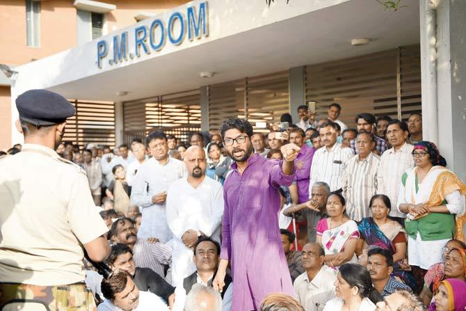 MLA Jignesh Mewani (C) outside the Postmortem room at Civil hospital where the dead body of Bhanubhai Vanakar is kept. Pic/AFP
