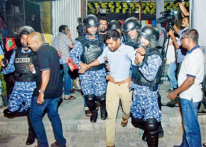 Maldivian police officers detain an opposition protestor demanding the release of political prisoners during a protest in Male. Pic/AFP