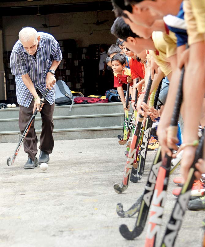 Hockey coach Marzban Patel during a training session with kids at the Children