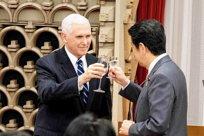 Mike Pence (left) cheers with Japan