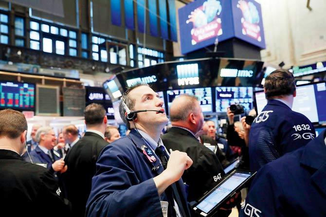 Traders on the floor of the New York Stock Exchange (NYSE). Stocks opened higher on Friday with the Dow up over 300 points. Pic/Getty Images/AFP