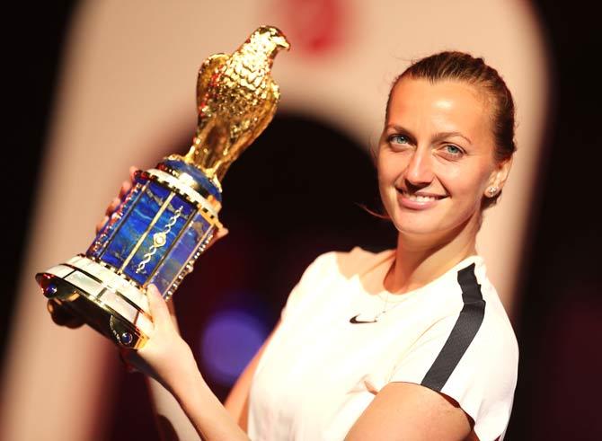 Petra Kvitova of the Czech Republic poses with her trophy on the podium after winning the final of the women