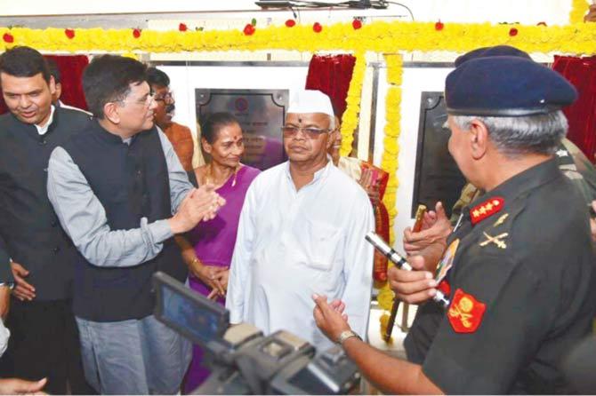 Railway Minister Piyush Goyal with flower vendor Shivraj Konde at Elphinstone Road station