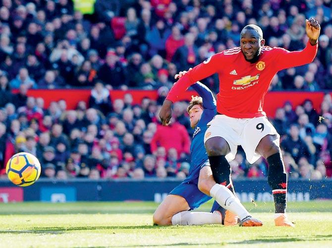 Romelu Lukaku (right) scores Manchester Uniteds first goal against Chelsea during an EPL match at Old Trafford yesterday. pic/Getty Images
