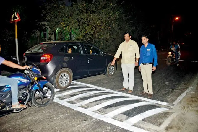 Sameer Vartak points to the newly painted speed breaker. Pic/Hanif Patel