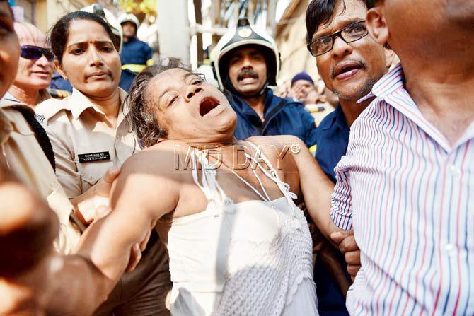 The police take her away kicking and screaming