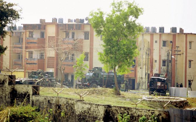 Security personnel (also below) take position around the family quarters of the Sunjuwan Military Station on Saturday. Four militants are believed to be holed up in the camp. Pics/PTI 