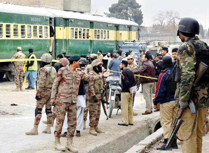 Pakistani police officers and paramilitary soldiers guard the site of a firing incident in Quetta, on Wednesday. Pic/AFP