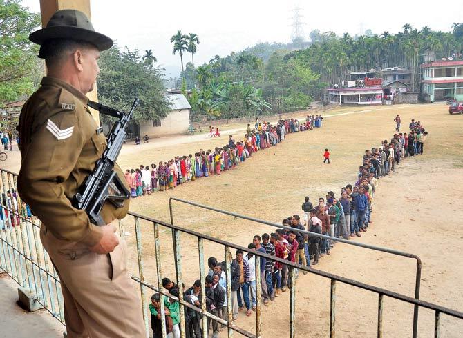 A security officer stands guard at Umtyrnga polling during the State Assembly elections, in Meghalaya, on Tuesday. Pic/PTI