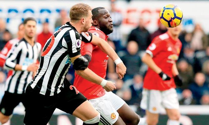 Newcastle Uniteds Florian Lejeune (left) and Manchester United Romelu Lukaku vie for the ball during an EPL tie yesterday. Pic/AFP