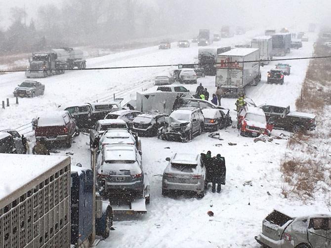 In this photo provided by KCCI-TV, emergency personnel tend to vehicles on Interstate 35 in Ames, Iowa, after dozens of vehicles collided on the snow-covered freeway Monday, Feb. 5, 2018, forcing the closure of the southbound lanes. Pic/AP/PTI