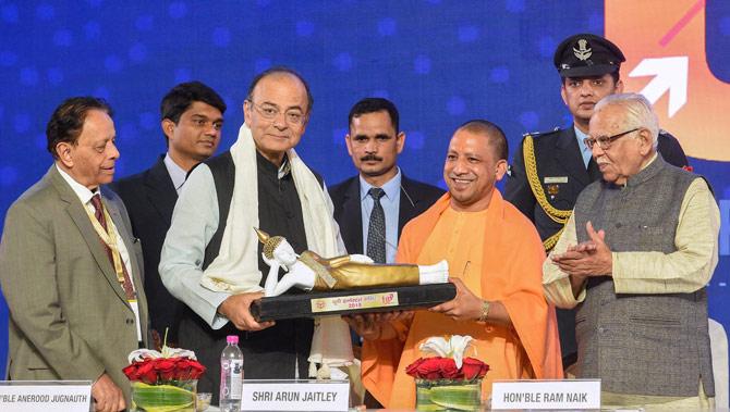 UP Chief Minister Yogi Adityanath presents a memento to Union Finance Minister Arun Jaitley as Governor Ram Naik looks on, during the UP Investors Summit at Indira Gandhi Prathishthaan in Lucknow on Thursday. Pic/PTI