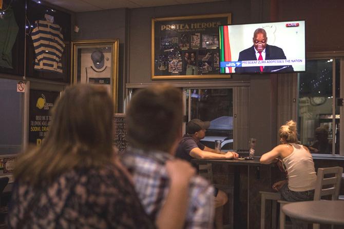 Customers watch a telecast in a bar in Randburg, Johannesburg, on February 14, 2018, as South African president Jacob Zuma makes a live address to the nation on the South African Broadcasting Corporation (SABC) network from The Union Buildings in Pretoria. South African President Jacob Zuma announced his immediate resignation in a television address to the nation on February 14, 2018, after the ruling ANC party threatened to eject him from office via a parliamentary vote of no confidence. Pic/AFP