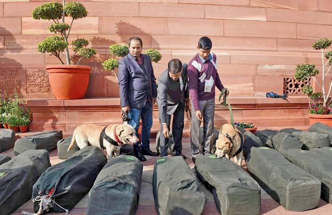 Security personnel check bags containing the general Budget documents, outside the Parliament House in New Delhi, this morning. Pic/AFP