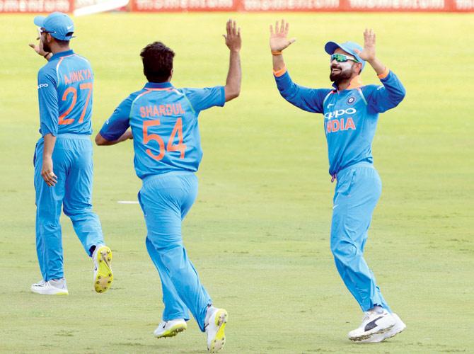 Skipper Virat Kohli (right) and Shardul Thakur celebrate a South African wicket during the 6th ODI at SuperSport Park on February 16 in Pretoria. Pic/Getty Images